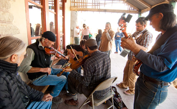 Musicians jam on the porch.